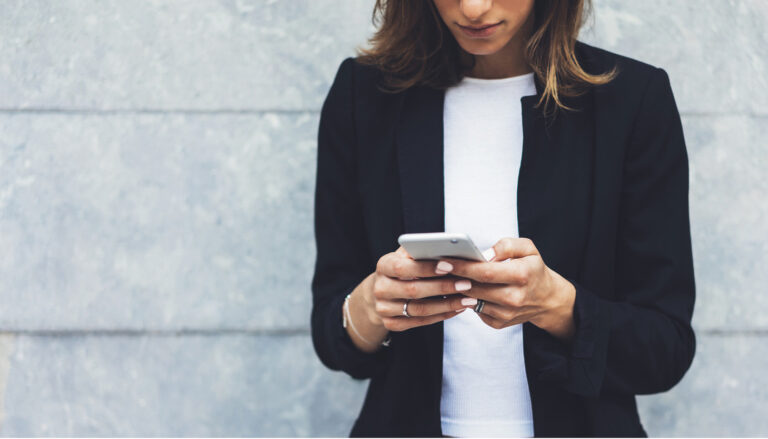 A woman browses the apps on her phone.