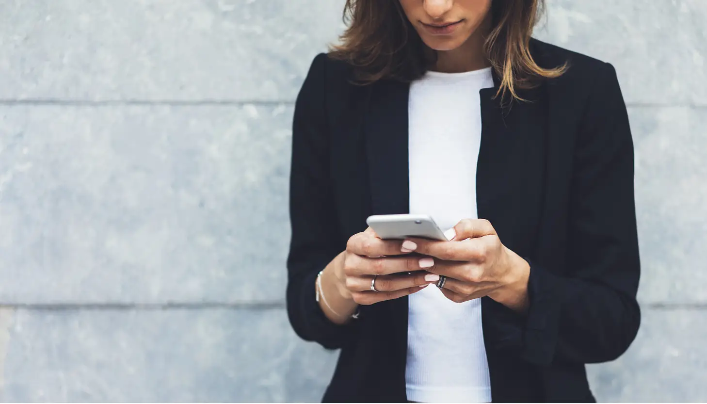A woman browses the apps on her phone.