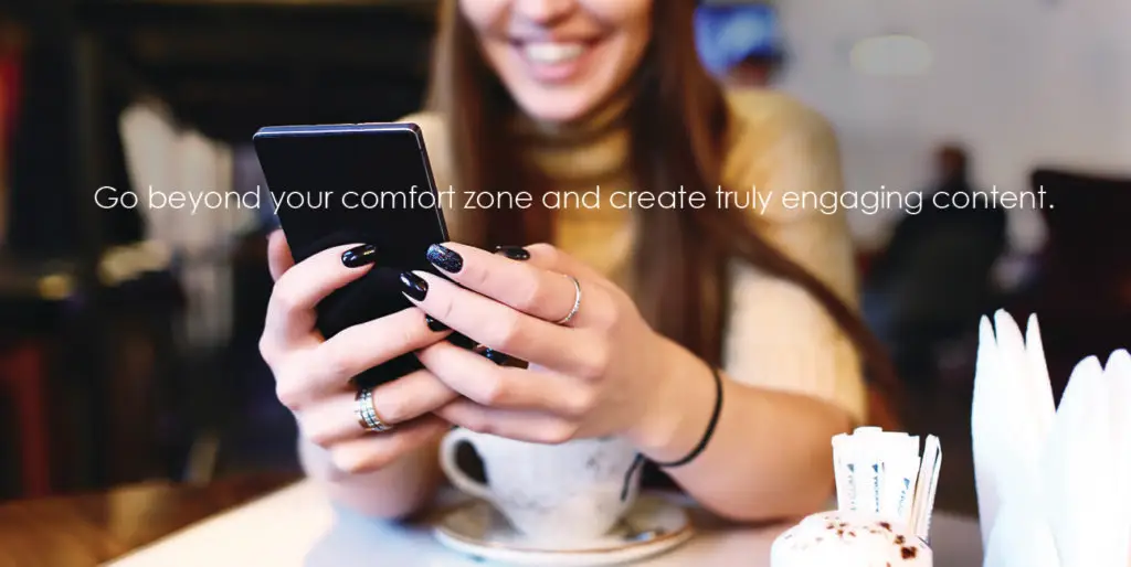 A woman browses Facebook on her phone while white text reads, "Go beyond your comfort zone and create truly engaging content."