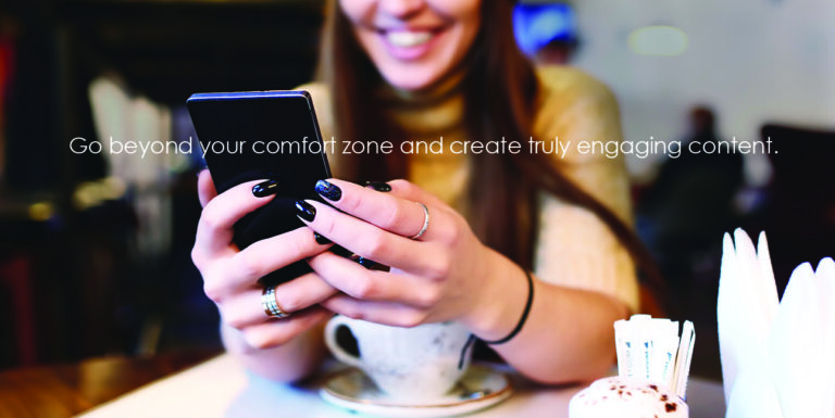A woman browses Facebook on her phone while white text reads, "Go beyond your comfort zone and create truly engaging content."