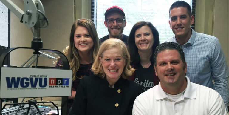 The Your Biz Your Town crew smiles at the camera.