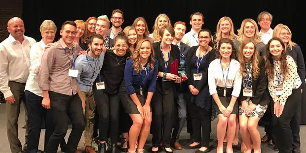 The 8THIRTYFOUR team smiles at the camera.