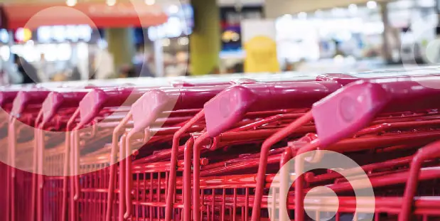 Shopping carts are lined up inside of a Target store.