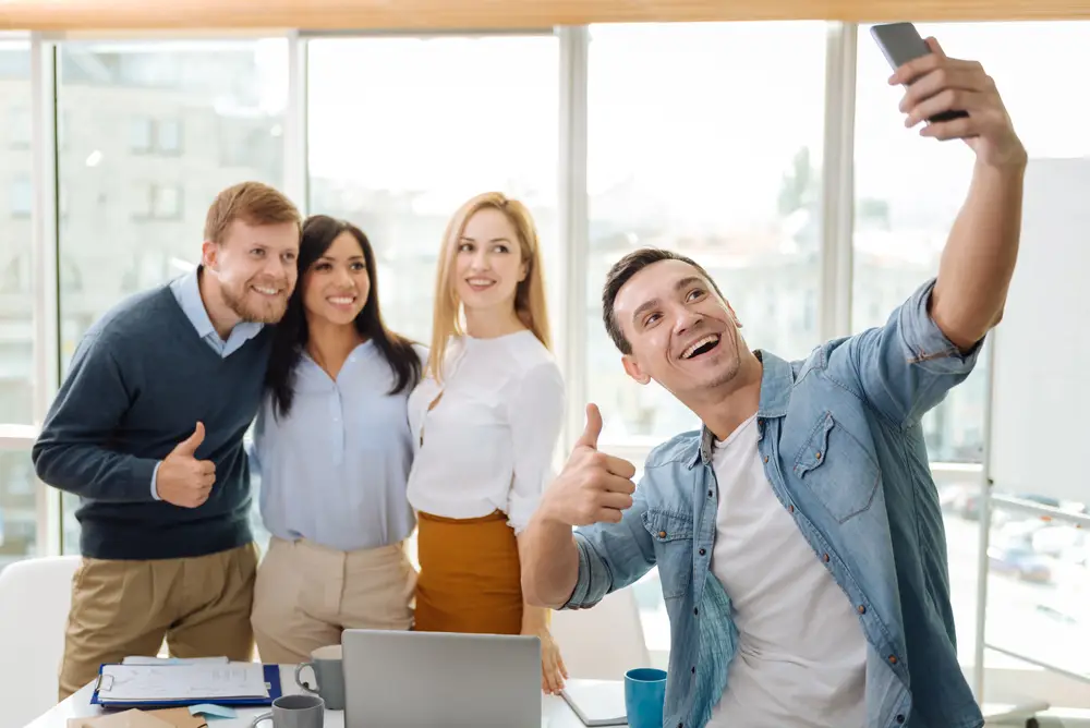 Several employees pose for a selfie