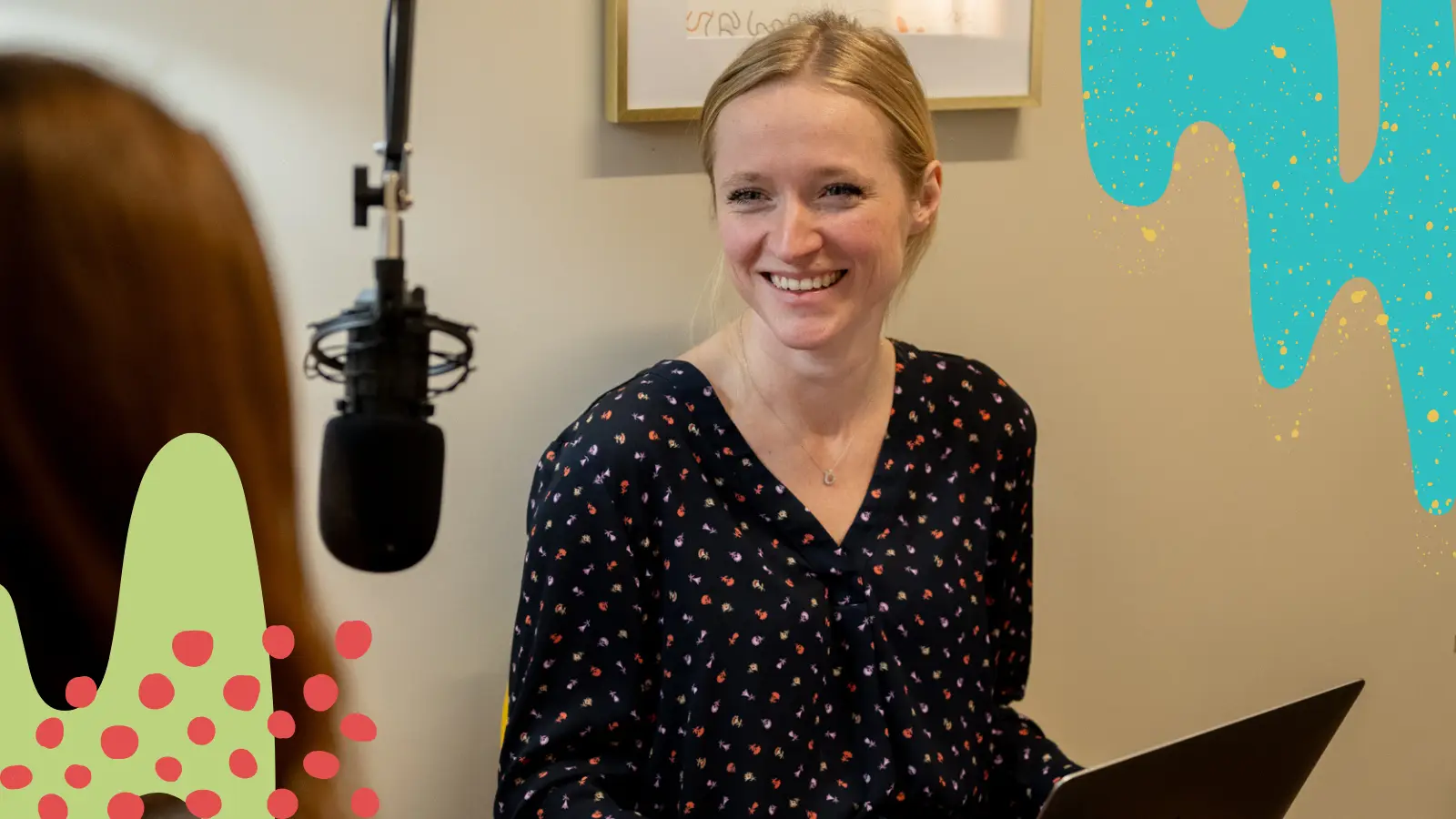 Maddie smiles while interviewing a podcast guest on Happy Hour Hustle.
