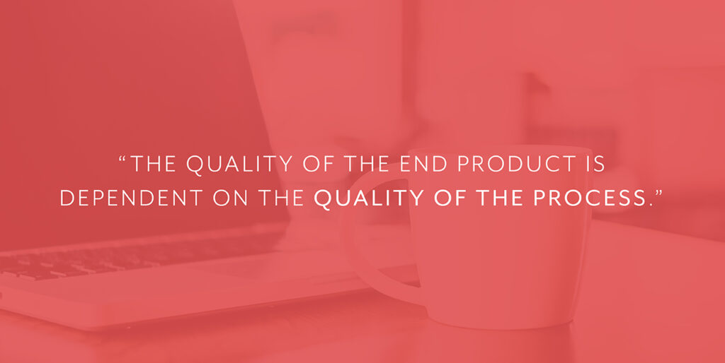 A coffee cup sits next to a laptop with white font that reads, "The quality of the end product is dependent on the quality of the process."