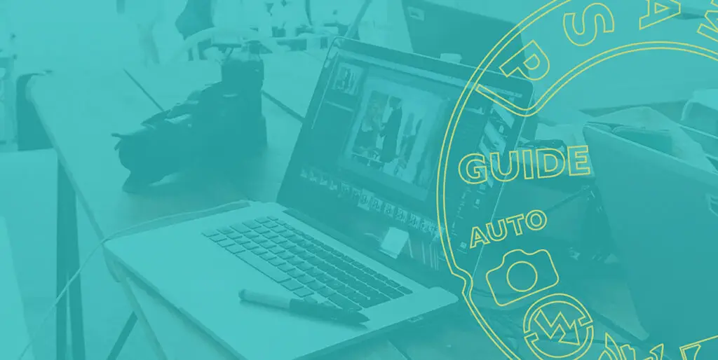 A laptop shows Adobe Lightroom CC while a tablet pen sits on the laptop and a camera rests behind