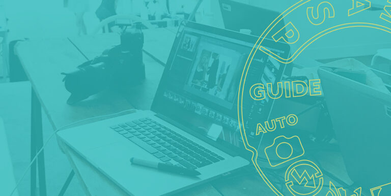 A laptop shows Adobe Lightroom CC while a tablet pen sits on the laptop and a camera rests behind