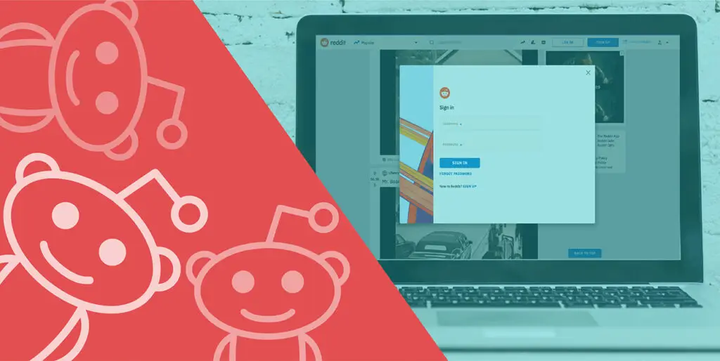 A laptop displays the sign in screen for Reddit while the Reddit logo is superimposed over the scene