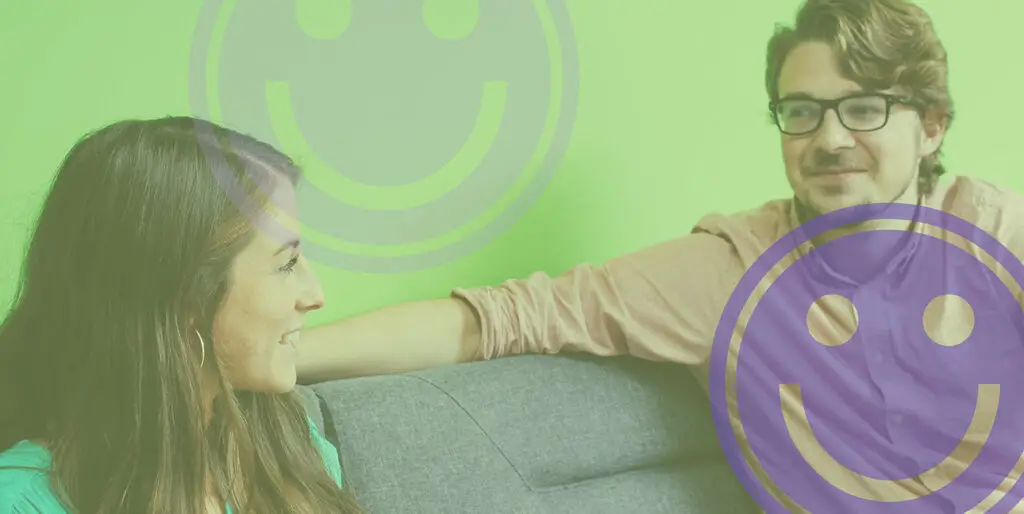 Emily Potts and Alex Rens smile on the couch at the 8THIRTYFOUR office