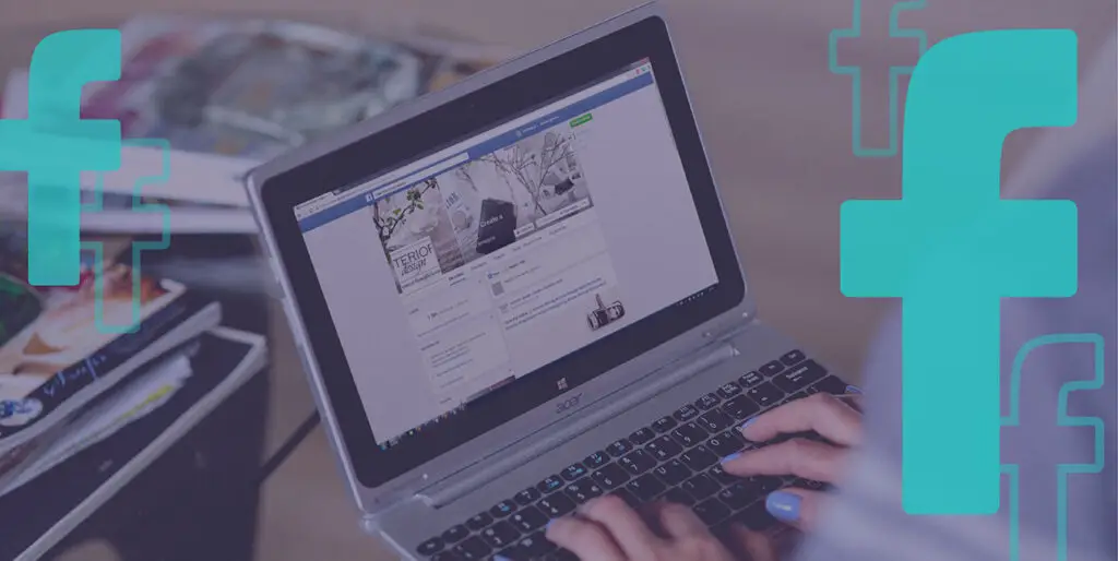 A person browses Facebook on their laptop
