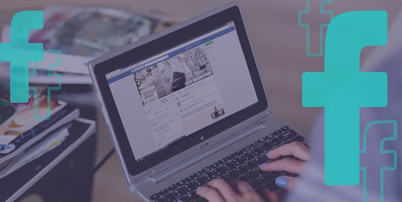 A person browses Facebook on their laptop