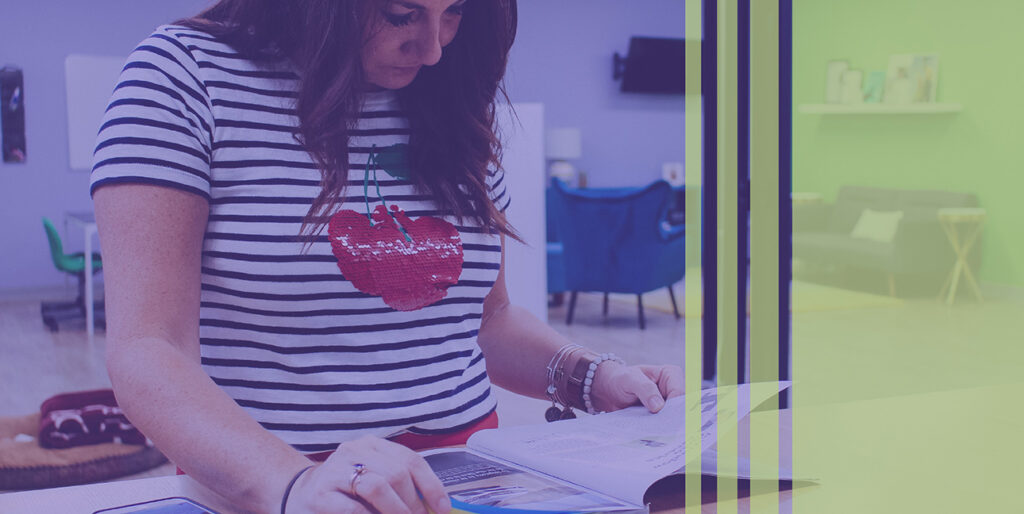 Kim Bode reads an industry article at the 8THIRTYFOUR office