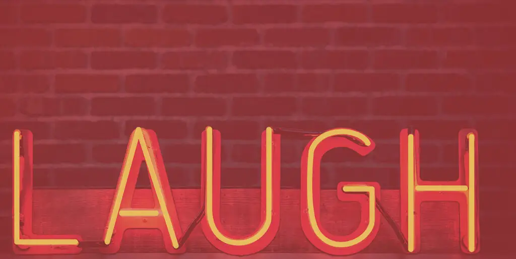 A neon sign spelling out the word, "Laugh"