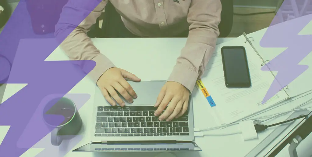 An employee works on a laptop at the 8THIRTYFOUR office