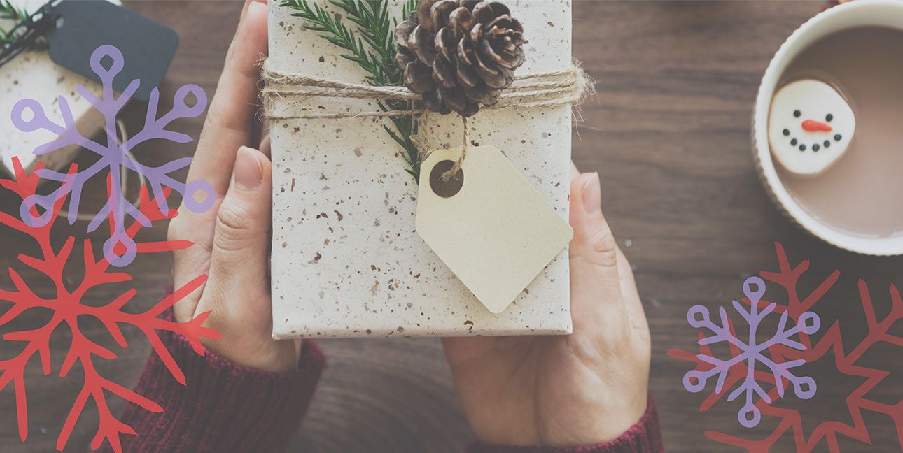 Two hands hold up a intricately wrapped present