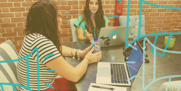 Kim Bode and Emily Potts discuss public relations at the conference table in 8THIRTYFOUR's office