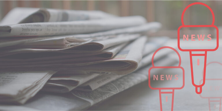 A stack of newspapers on a table with two cartoon microphones superimposed over them