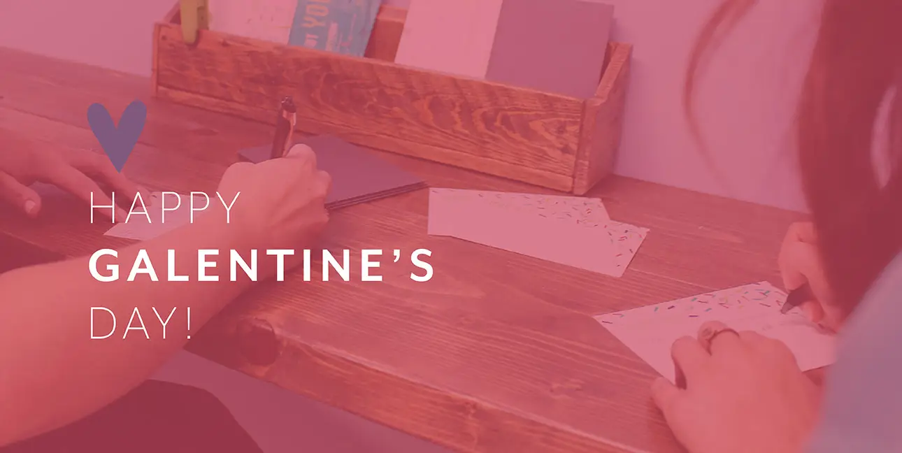 Kim Bode and Emily Potts write letters in the 8THIRTYFOUR office.