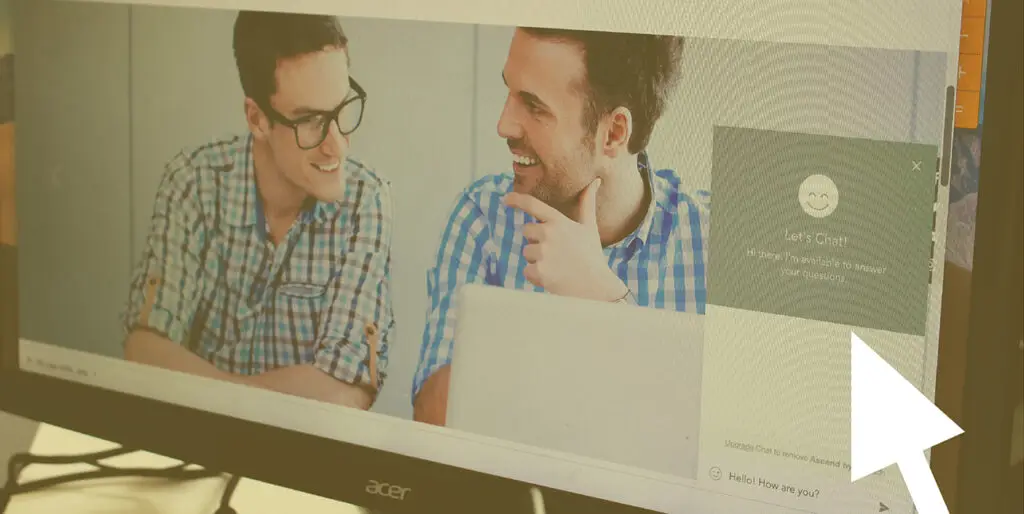 Megan Leo pulls up a chatbot on a website at their desk in the 8THIRTYFOUR office.