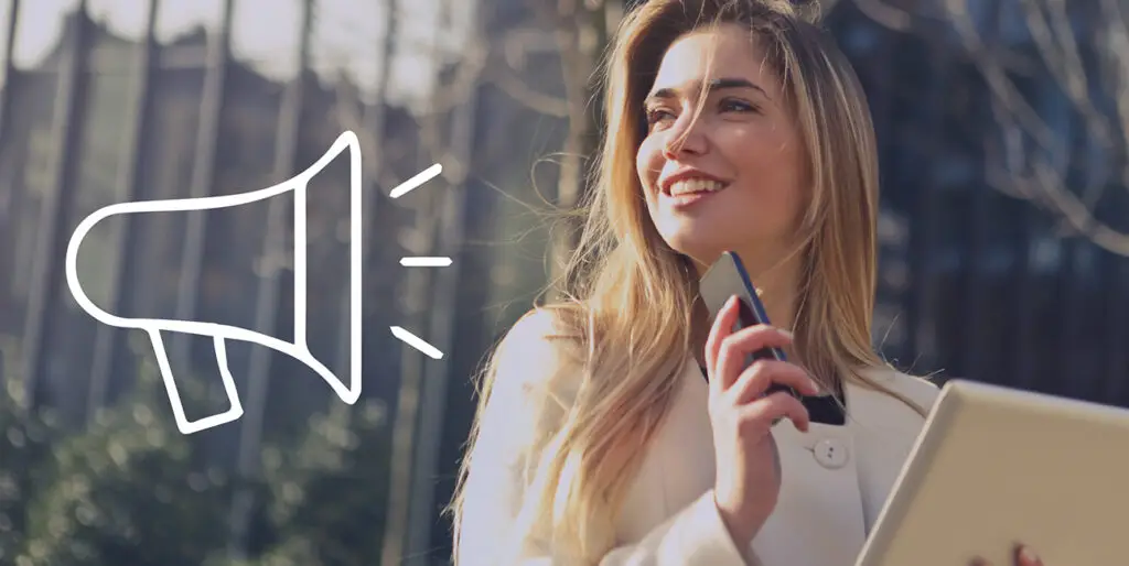 A young public relations professional smiles while thinking as a cartoon megaphone points at her.