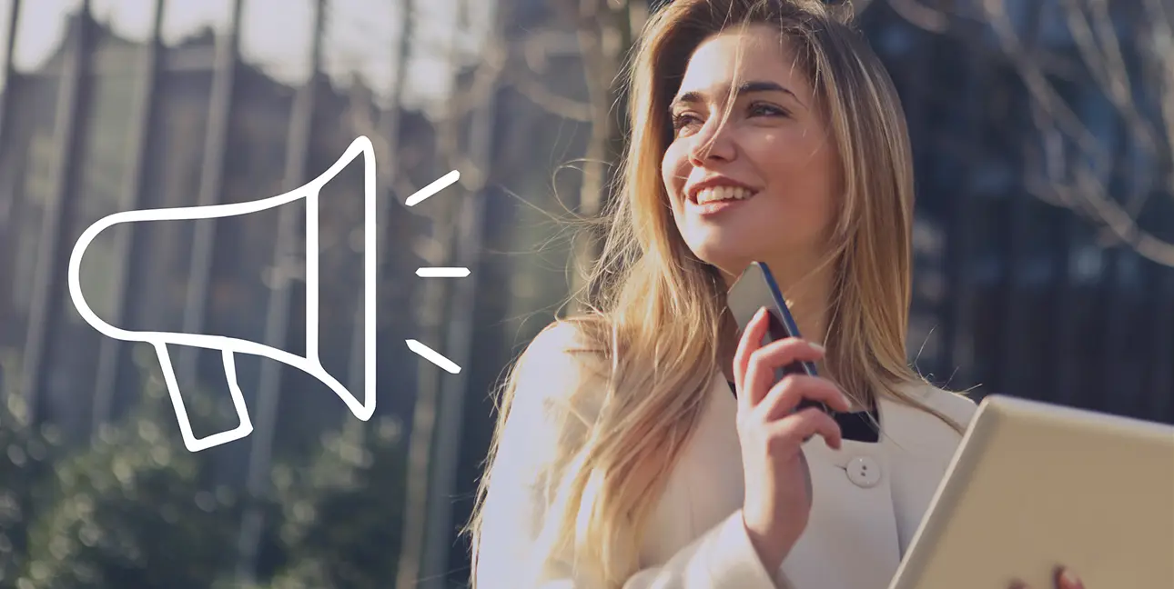 A young public relations professional smiles while thinking as a cartoon megaphone points at her.