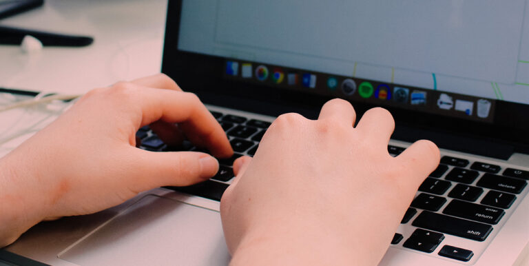 Rowan Leo types on their laptop inside of the 8THIRTYFOUR office.