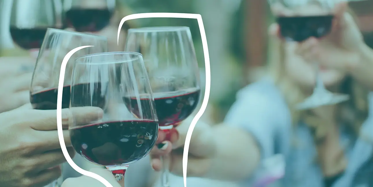 A photo of three people clinking wine glasses together.