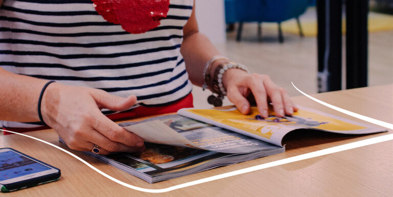 Jen Van Ee, Director of Client Success, flipping through a magazine.