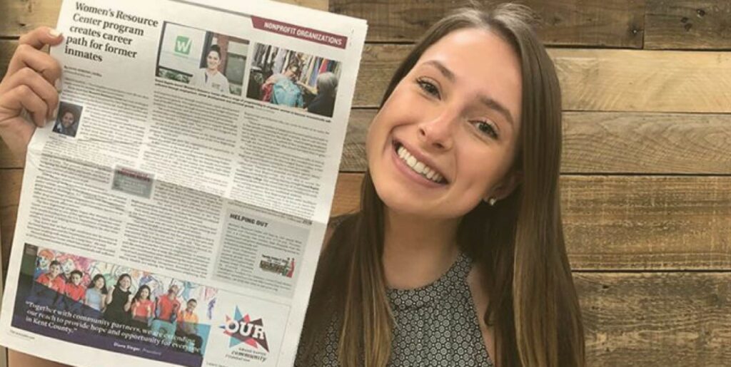 PR Specialist, Brianna Zimmer, holds up her first piece of earned media.