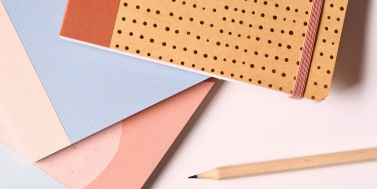 A picture of office supplies on a white table.