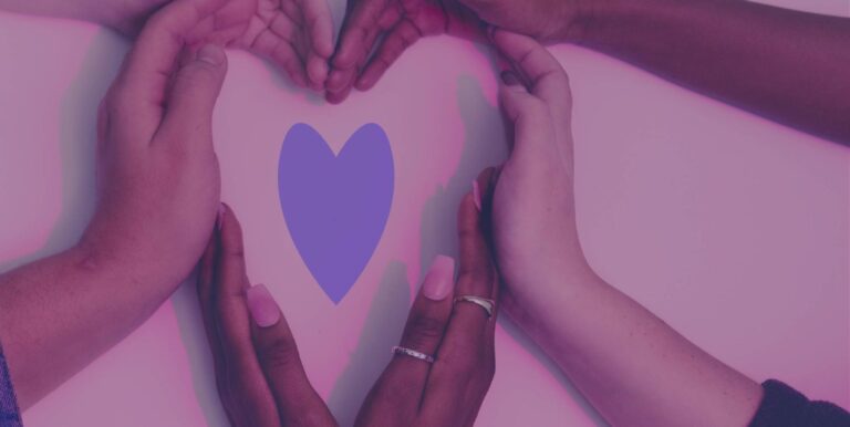 An image of a blue paper heart with hands surrounding it, also forming a heart.