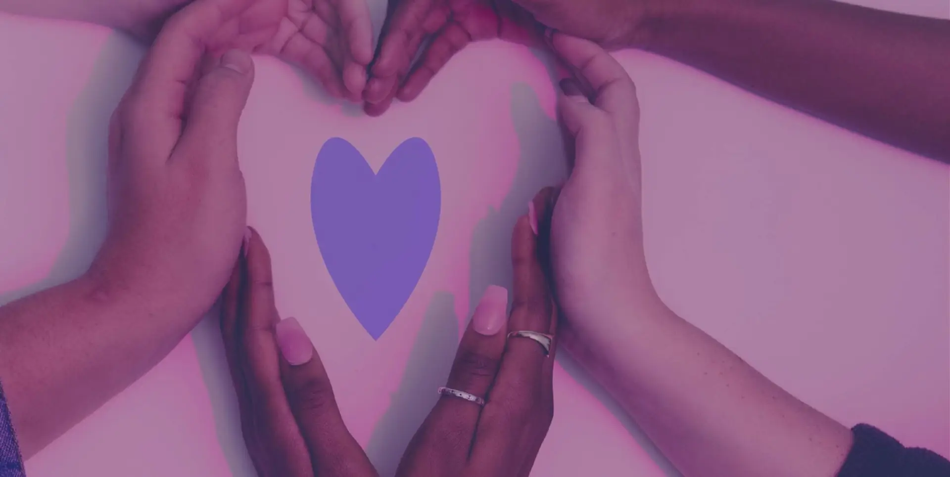 An image of a blue paper heart with hands surrounding it, also forming a heart.