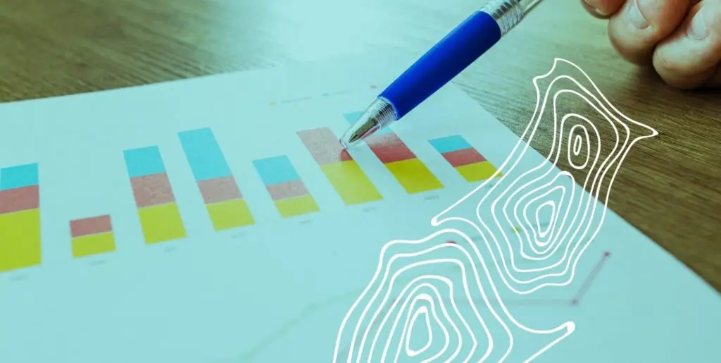 A pen resting against a piece of paper showing multiple bar graphs.