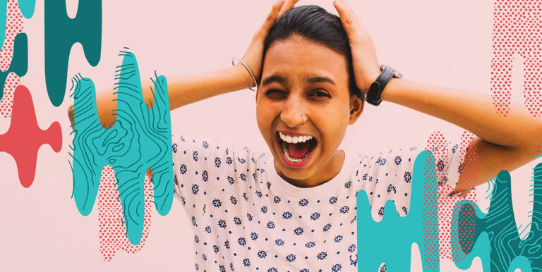 A woman screaming and holding her hands over her ears.