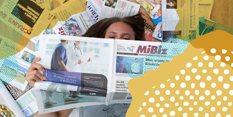 Brianna Zimmer laying on the ground covered in earned media.