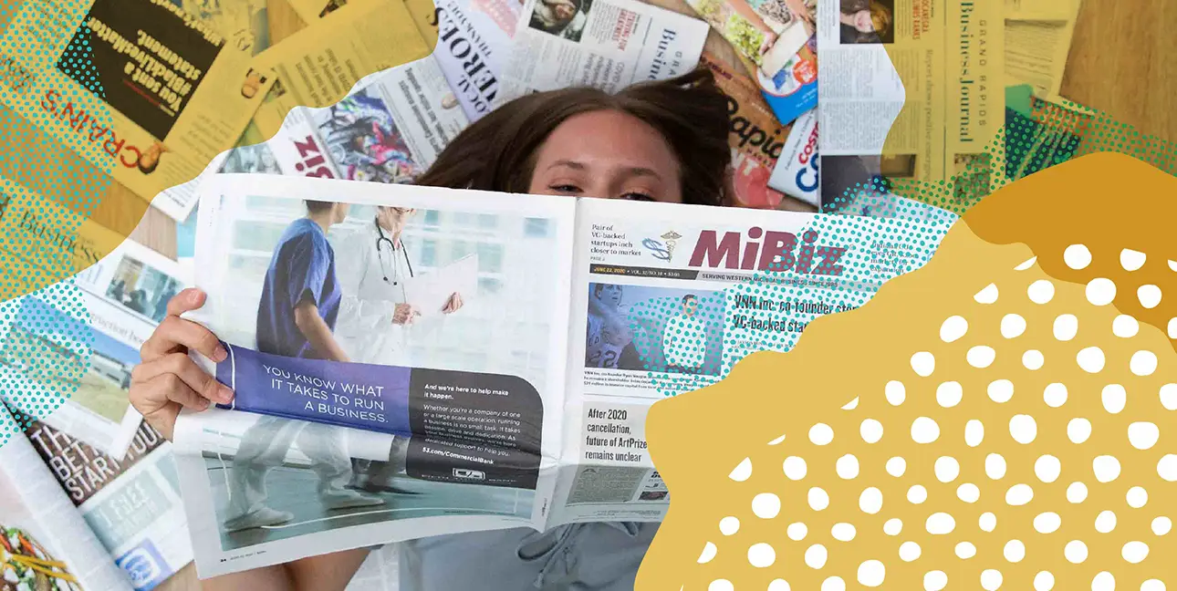 Brianna Zimmer laying on the ground covered in earned media.