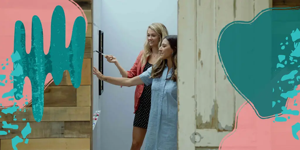 Digital Lead, Erica Statly, and Creative Lead, Chelsea Miller, reviewing a strategy on the whiteboard in the 8THIRTYFOUR office.