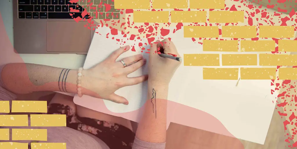 An overhead image of a person writing in a notebook.