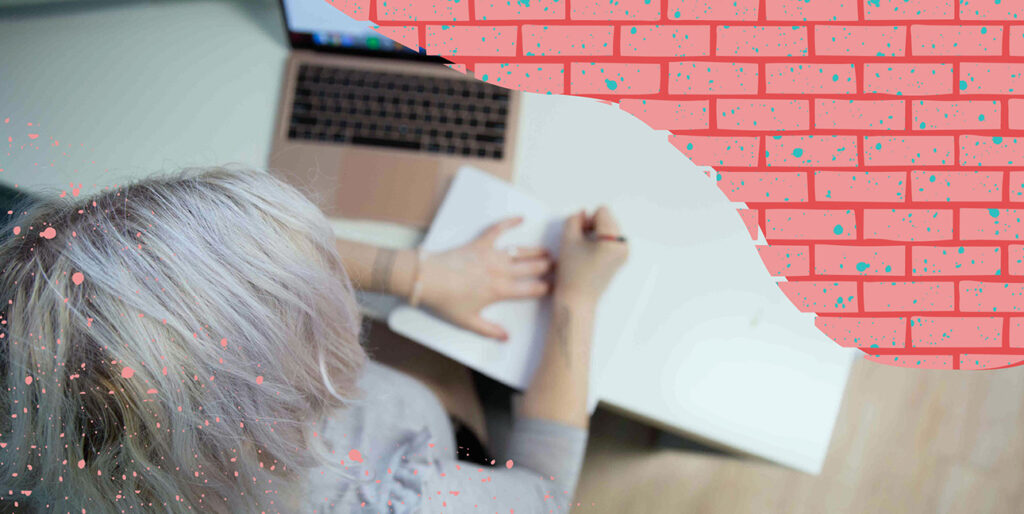 A person writing in a notebook.