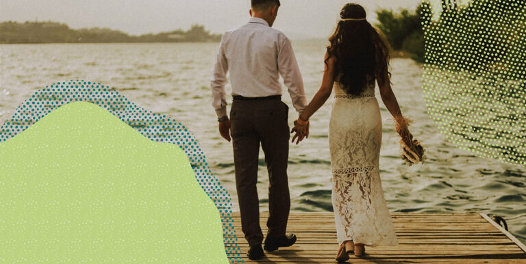 a couple holding hands and walking on a dock