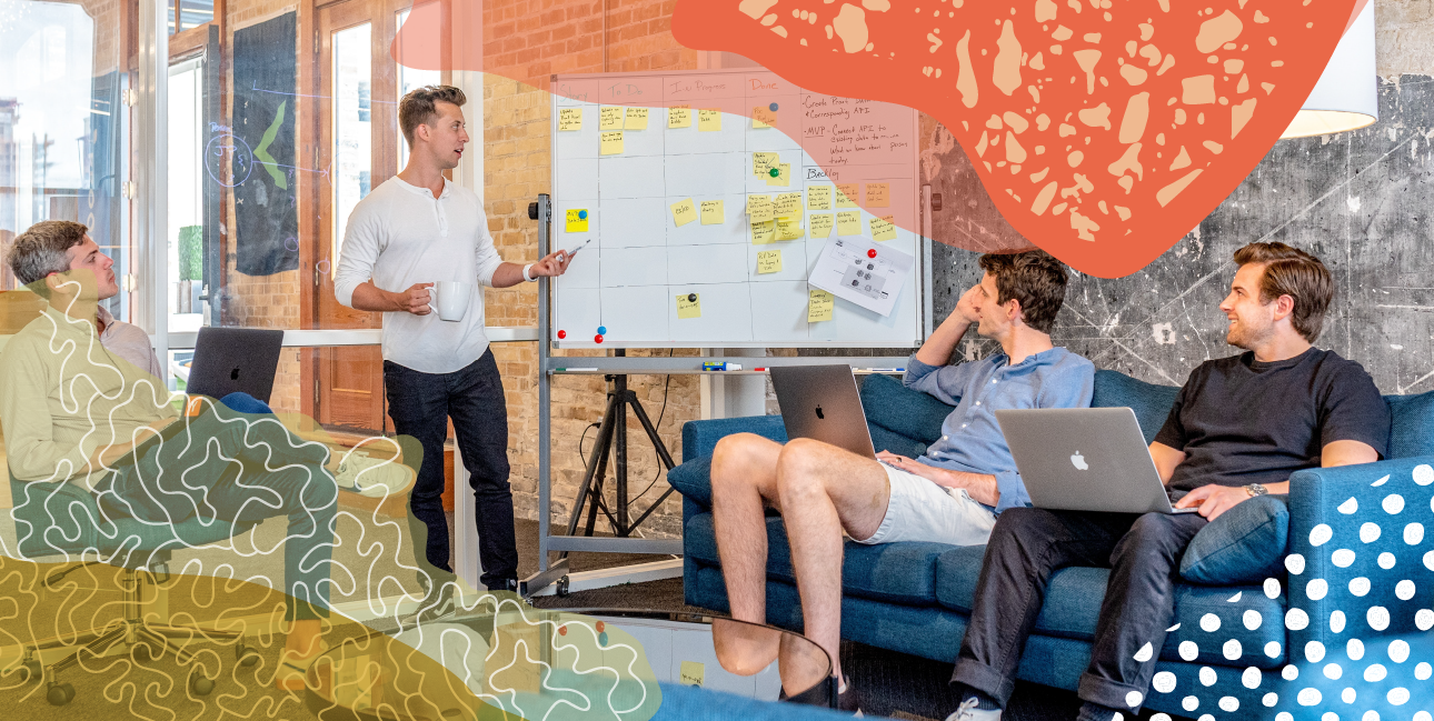 A man giving a presentation in front of a whiteboard