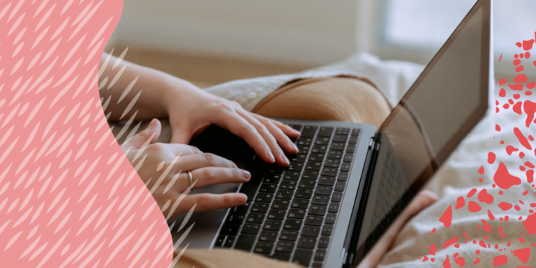 Hands typing on a laptop