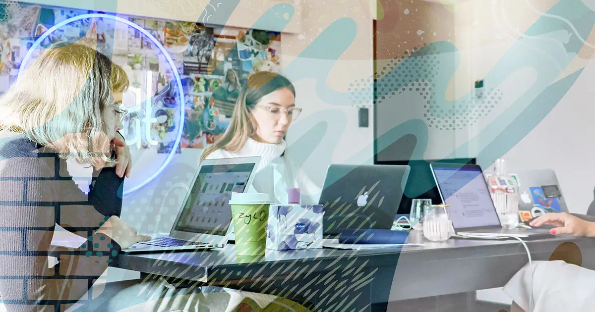 Four People at a Conference Table Working Together