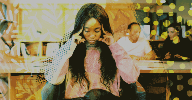 Woman with hands on her head with people walking behind her