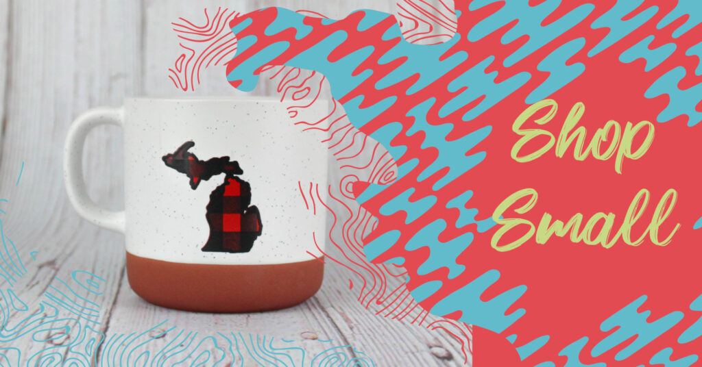 A white mug with the state of Michigan outline on it, with the text "Shop Small."