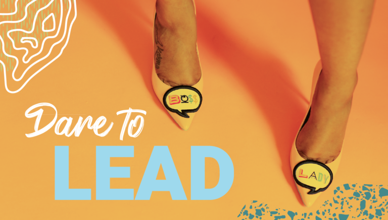 A woman's feet with high heels that say "Boss" and "Lady"