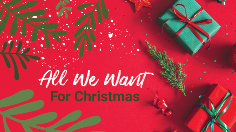 Some gifts and Christmas decorations lie on top of a red table "All We Want for Christmas"