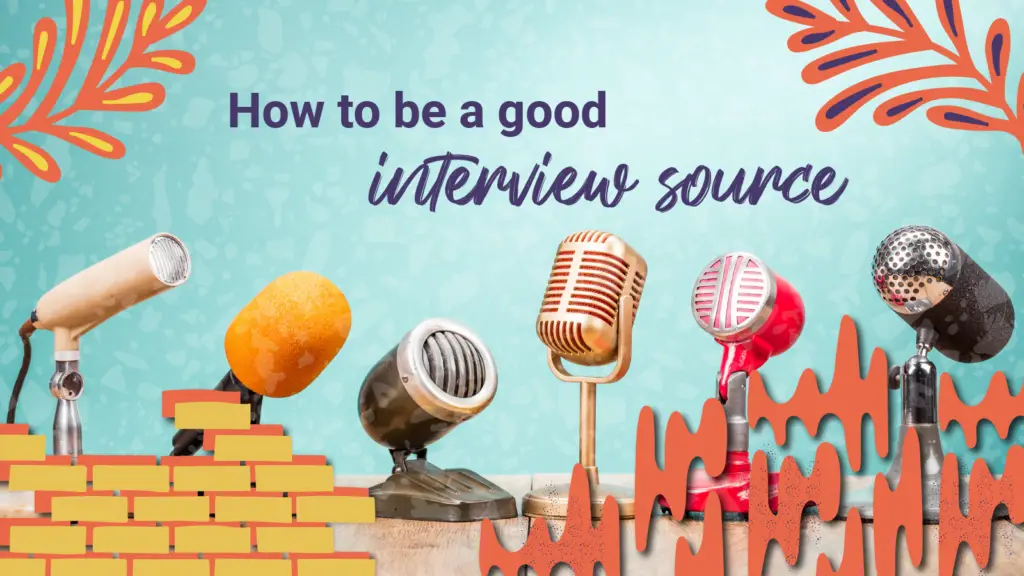 A line of microphones stand on a hardwood desk under the words "how to be a good interview source"