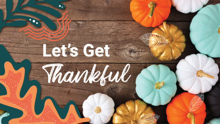 An array of different colored pumpkins sit on top of a wooden table "Let's Get Thankful"